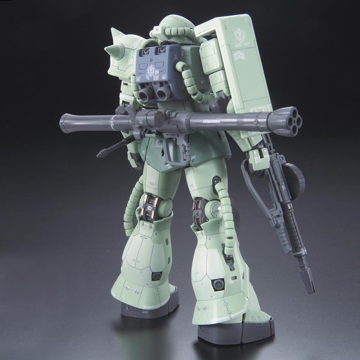 Model kit of a green robot with large weapon on a dark background