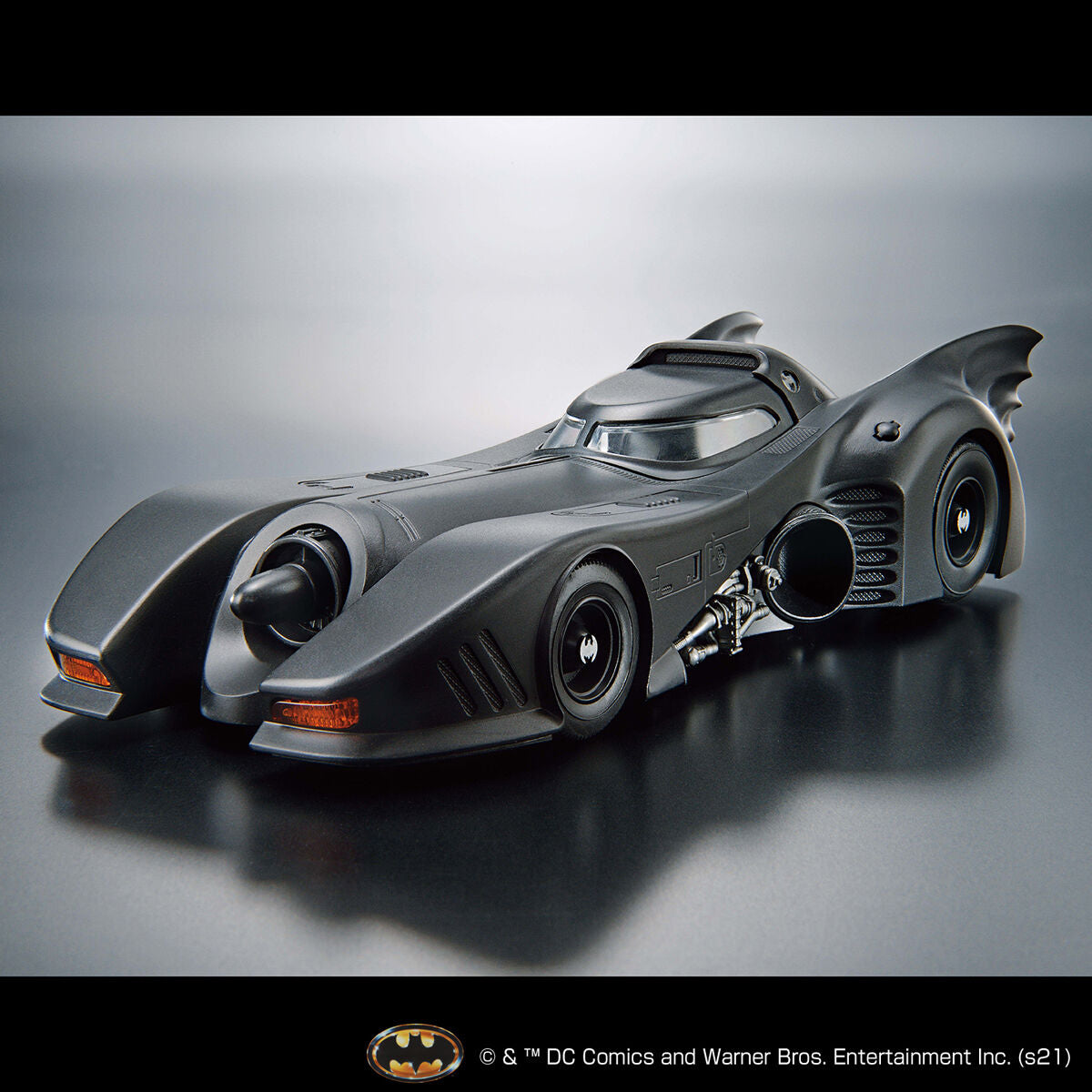 Model of the Batmobile on a reflective surface with a gray background
