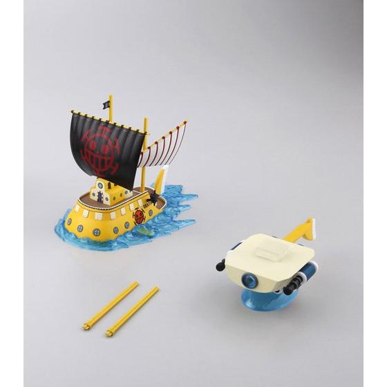 Toy pirate ship with a smaller boat on a gray background