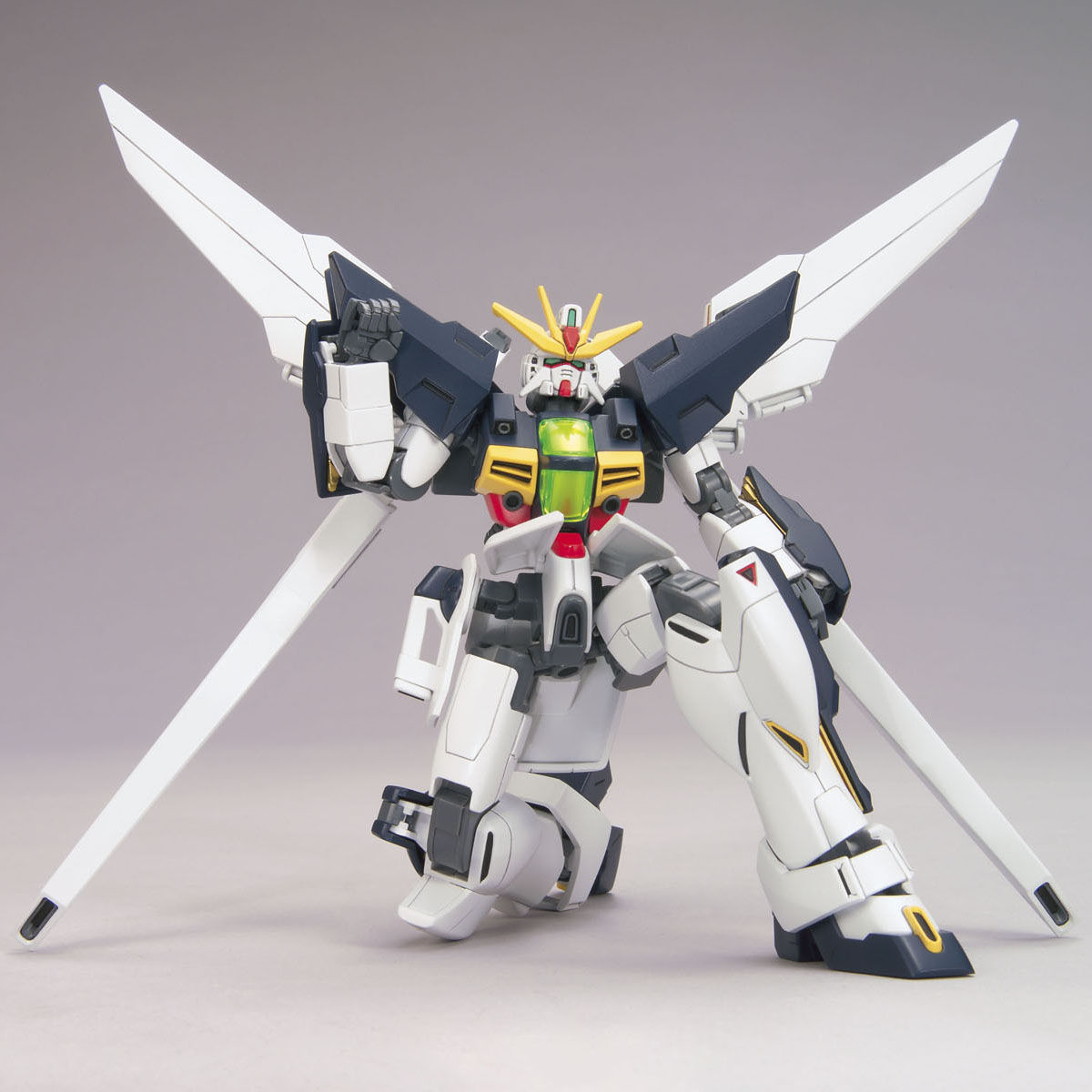 Model kit of a robot with white, black, and green colors on a gray background