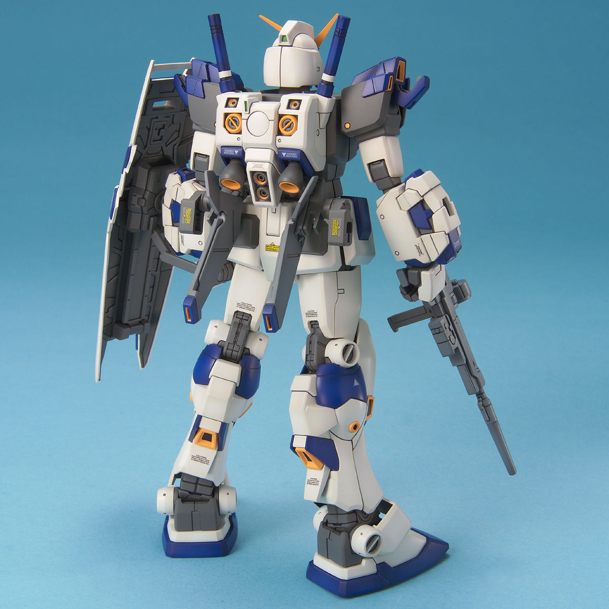 Model kit of a robot with white, blue, and gray color scheme on a blue background