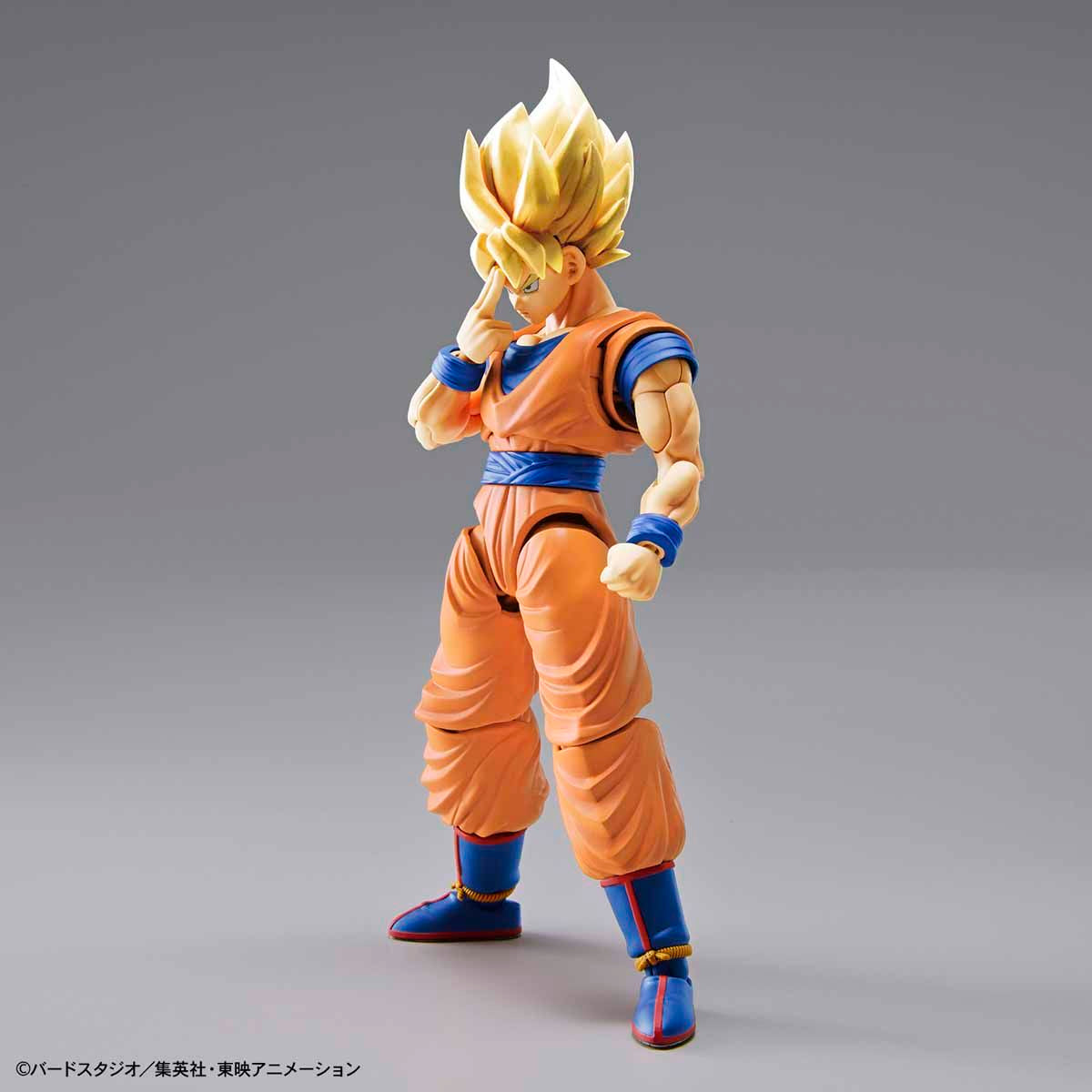 Action figure of a character in orange and blue outfit on a gray background