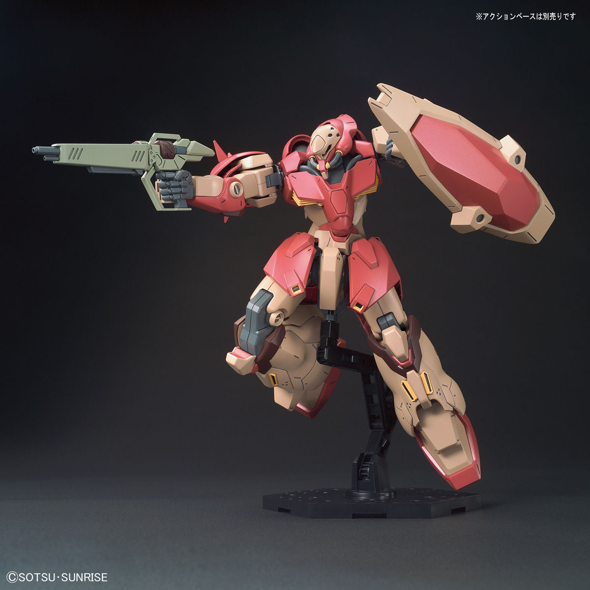 Model kit of a robot with red and beige color scheme on a dark background