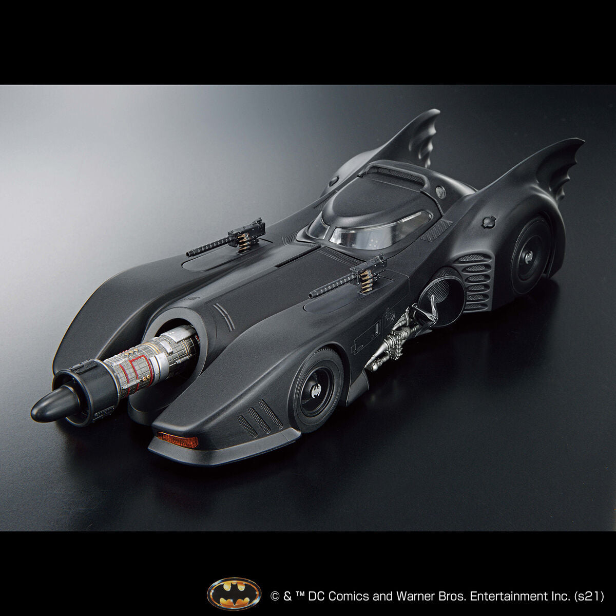 Model of the Batmobile on a reflective surface with a dark background