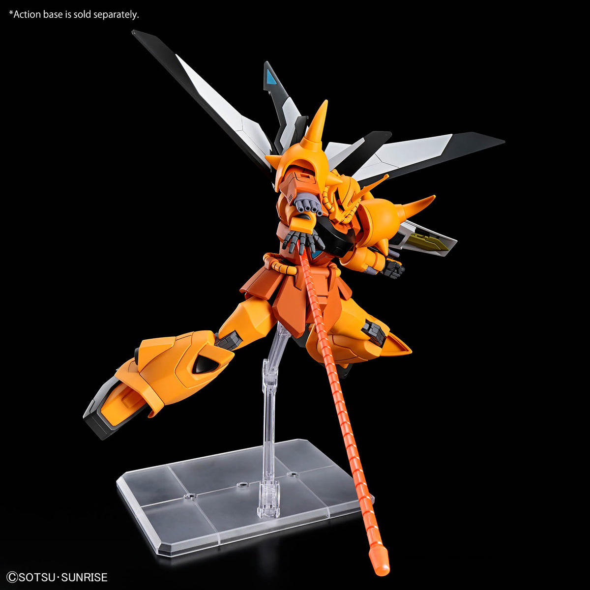 An orange and black Gundam-style action figure posed on a clear plastic display stand against a black background, holding a long orange weapon. The figure has white and gray wing-like elements extending from the back.