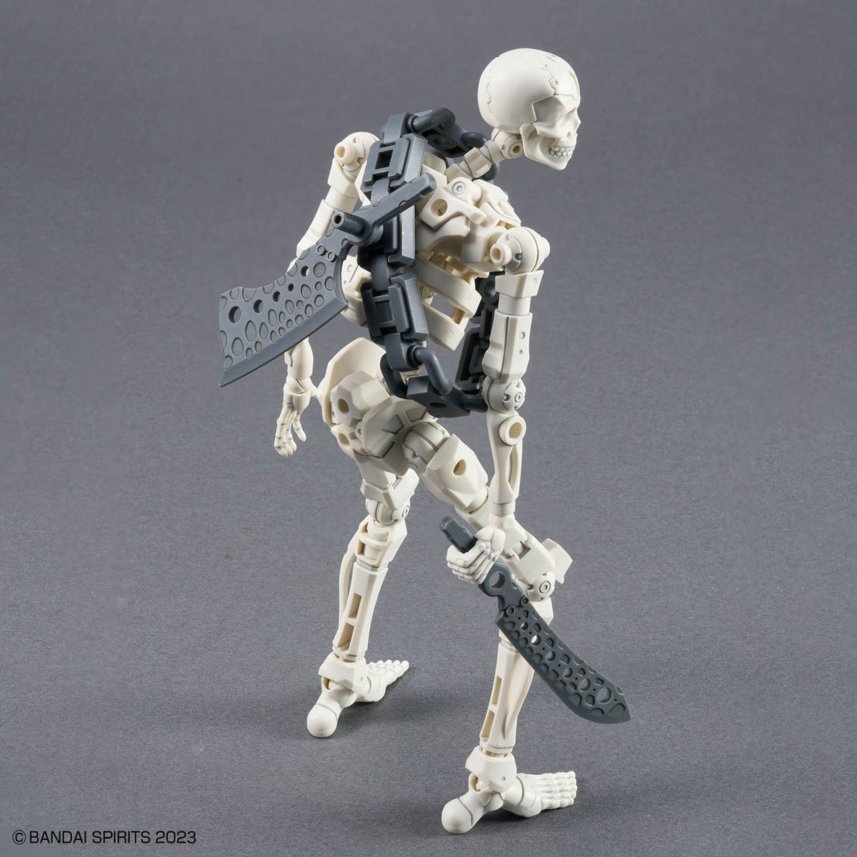 Mechanical skeleton figure with weapons on a gray background