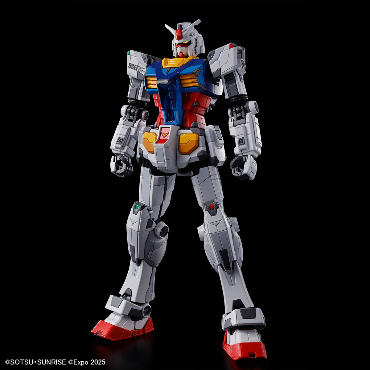 Model kit of a robot with gray, blue, and red color scheme on a black background