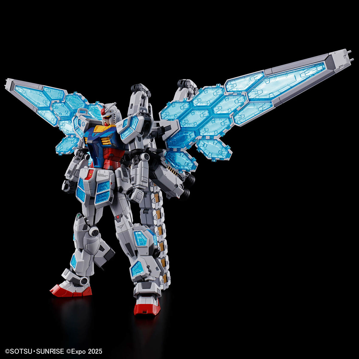 A highly detailed sci-fi mecha model with a white and gray body, blue translucent wing-like panels, and red and blue accents, posed against a solid black background.