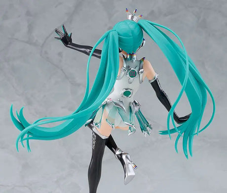 Figurine with turquoise hair and black and silver outfit on a gray background