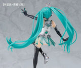 Action figure with teal hair and black and silver outfit on a gray background