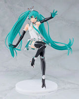 Figurine of a character with teal hair and black and white outfit on a gray background