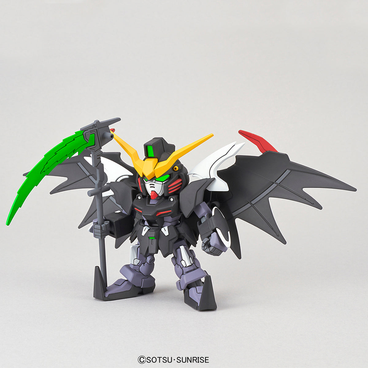 Toy robot figure with green and red accents on a gray background