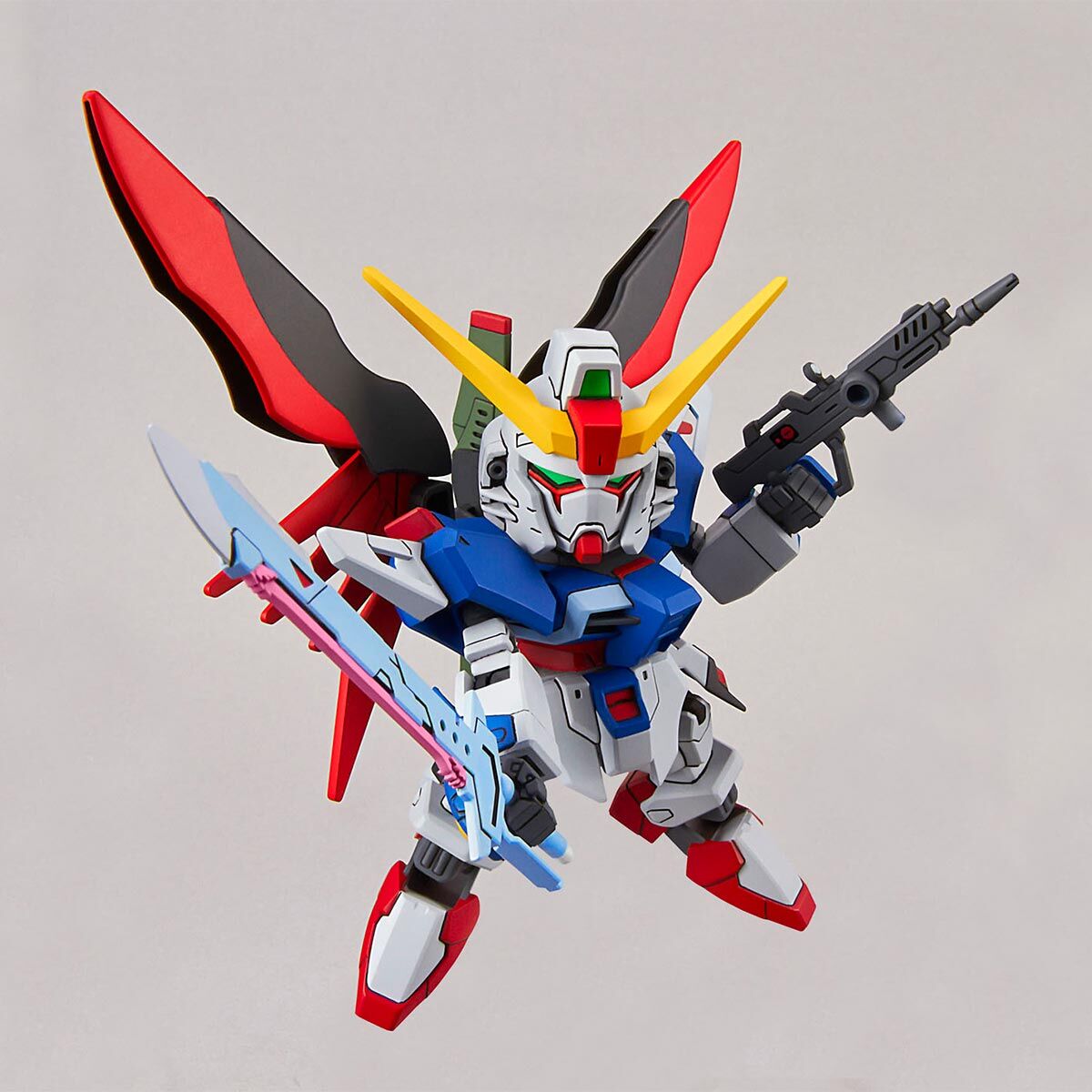 Toy robot figure with red, yellow, blue, and white colors on a gray background