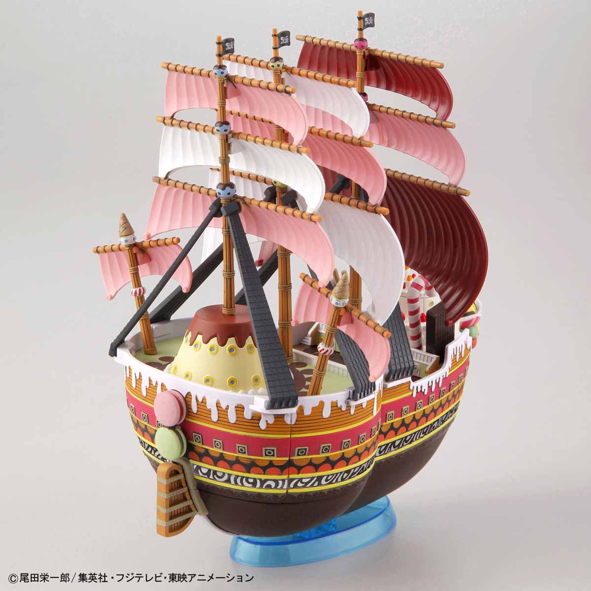 Model ship with pink sails on a white background