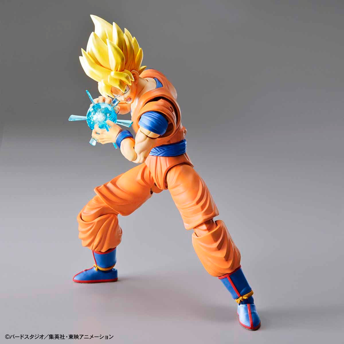Action figure in orange and blue outfit with a gray background