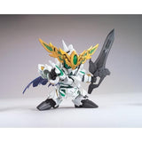 A small white mecha action figure holding a large dark gray sword, with gold wing-like armor details, green accents, and blue wing elements, photographed on a plain light gray studio background.