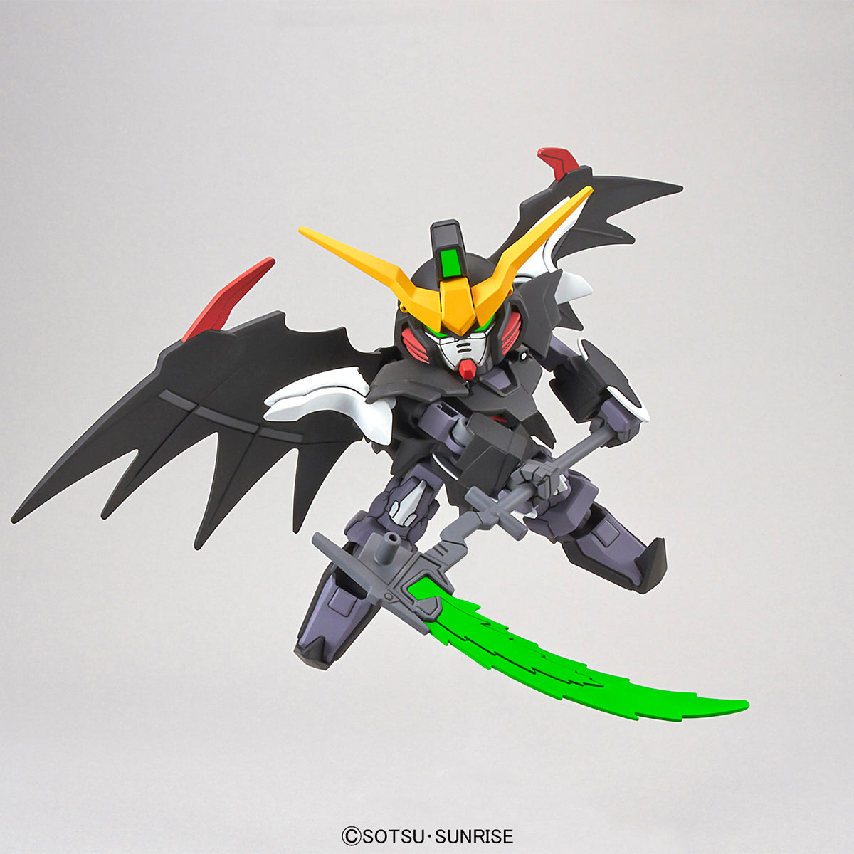 Toy robot with black, yellow, and green design on a gray background