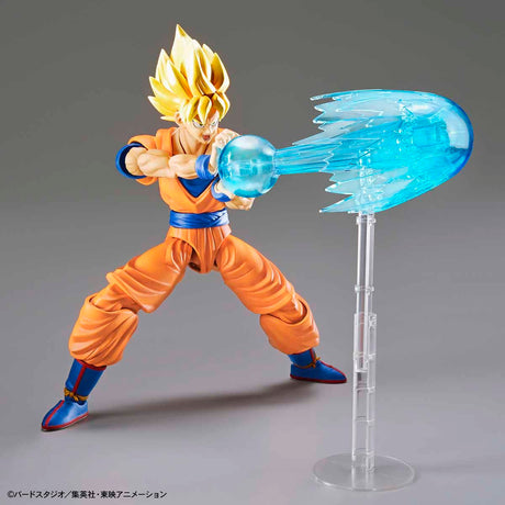 Action figure of a character in an orange and blue outfit with a blue energy blast on a gray background