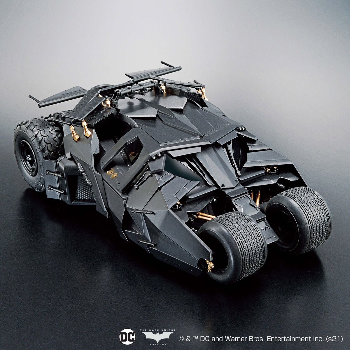 Model of a Batmobile on a reflective surface with a gray background