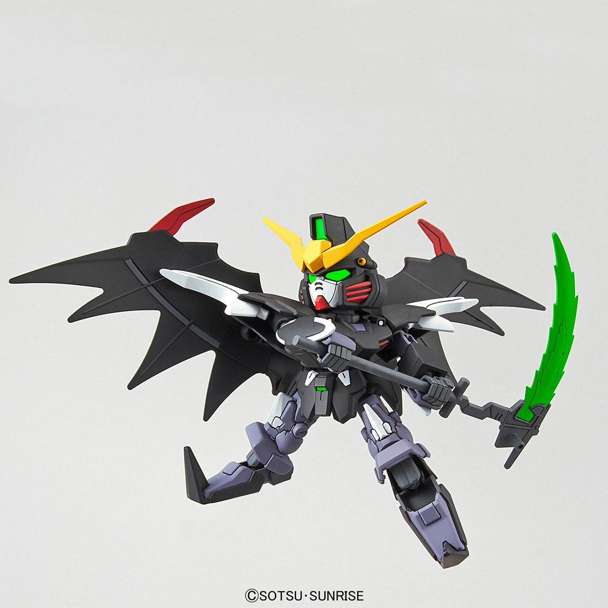 Toy robot with black wings and green sword on a gray background
