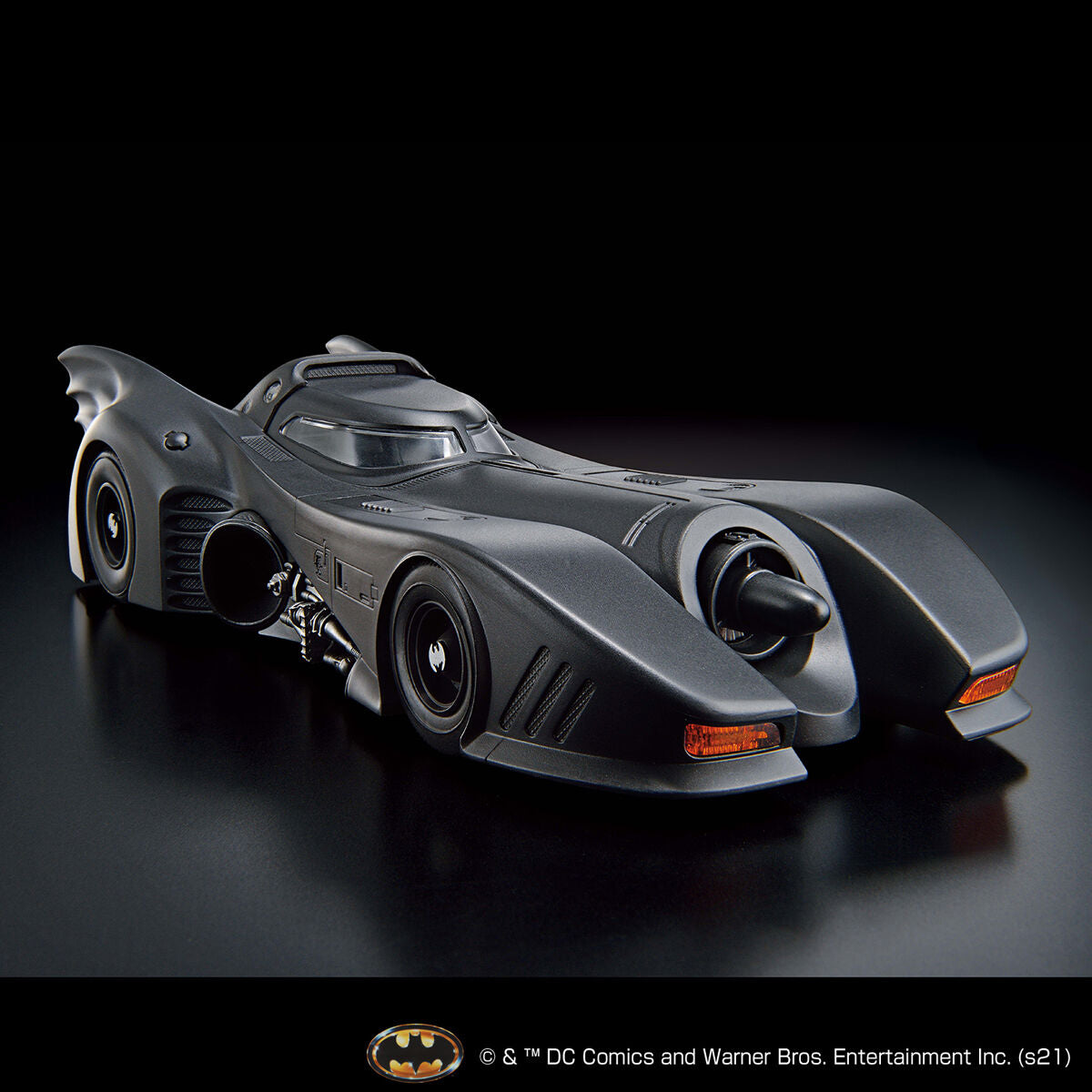 Gray Batmobile model on a black background with DC Comics logo.