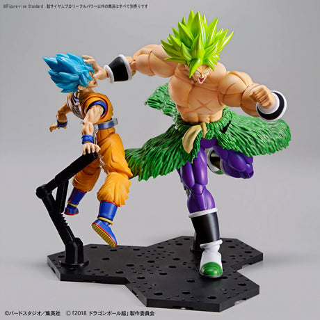 Two action figures on a gray background, one with blue hair and orange outfit, the other with green hair and purple outfit.