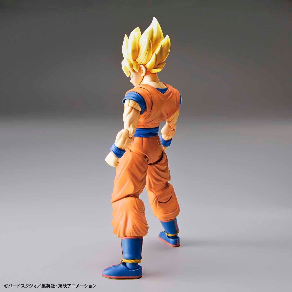 Super Saiyan character figure in orange and blue outfit on a gray background