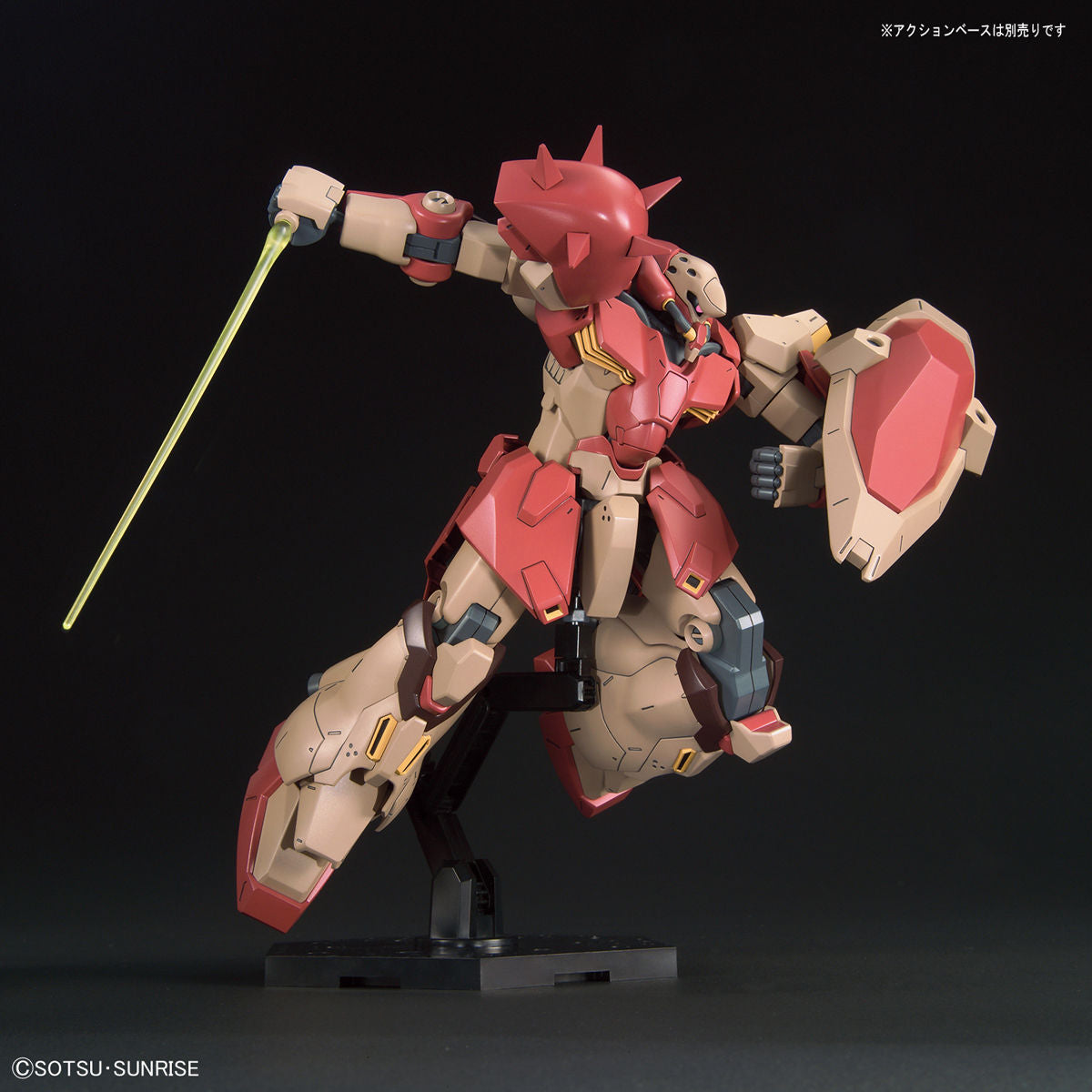Model kit of a red and beige robot with a yellow weapon on a black background