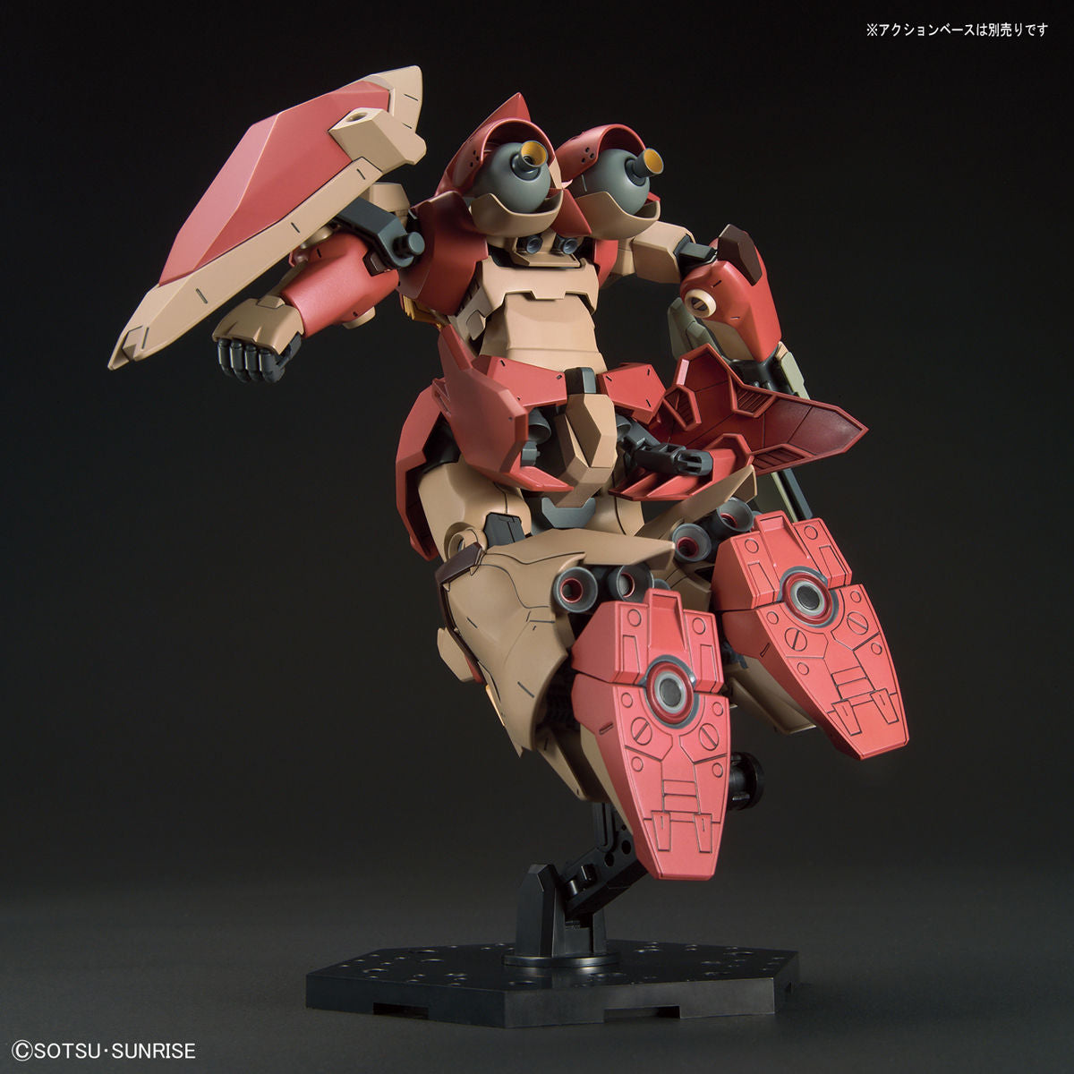 Model kit of a robot with red and beige color scheme on a black background