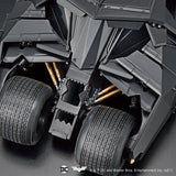 Close-up of a dark gray vehicle with visible suspension and tires.