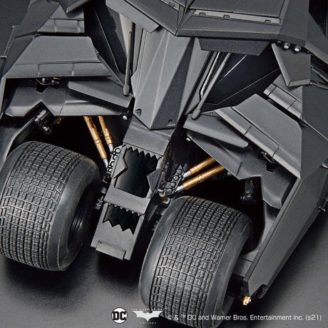 Close-up of a dark gray vehicle with visible suspension and tires.