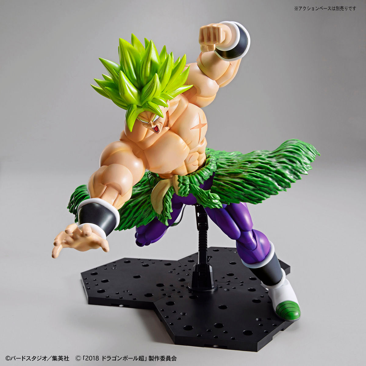 Action figure of a character with green hair and purple outfit on a gray background