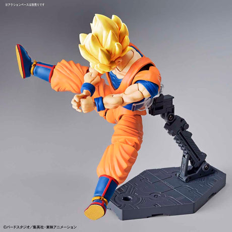 Model kit of a character in an orange and blue outfit on a gray background