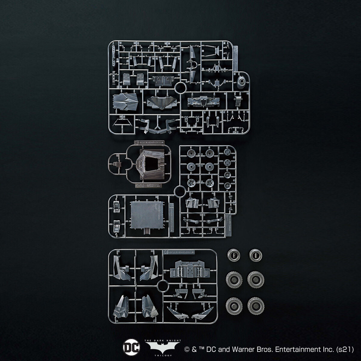 Model kit components on a black background with DC Comics logo.