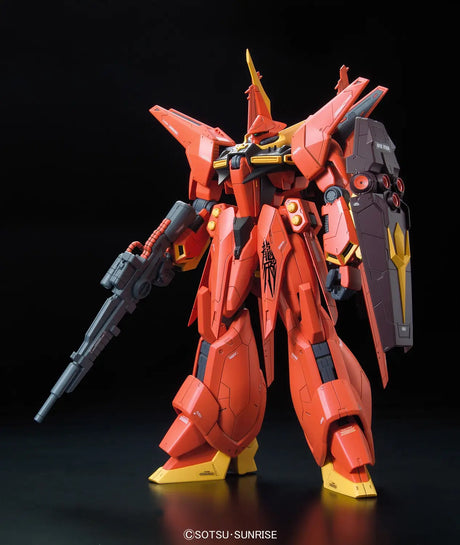 A red mecha robot model standing on a black surface against a black background, holding a gray rifle and wearing a gray shield with yellow accents. A copyright watermark for Sotsu Sunrise is visible at the bottom.