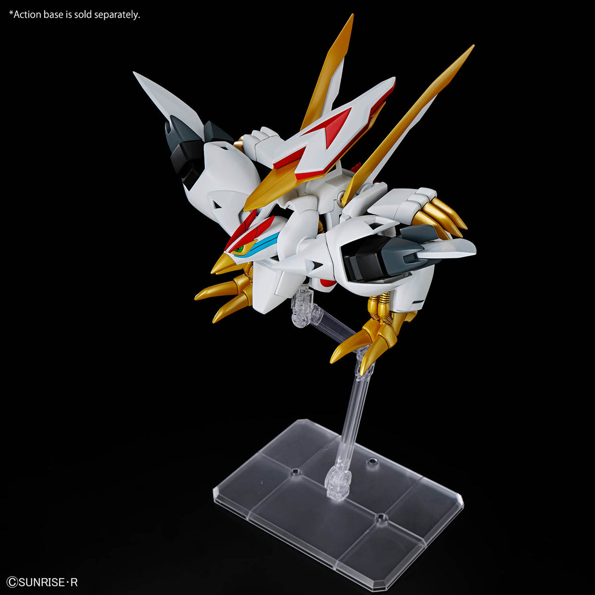 Model kit of a robot with gold and white design on a clear stand against a black background