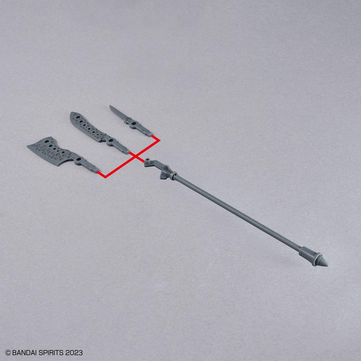 Model kit of a weapon with parts on a gray background, featuring Bandai Spirits branding.