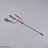 Model kit of a weapon with parts on a gray background, featuring Bandai Spirits branding.