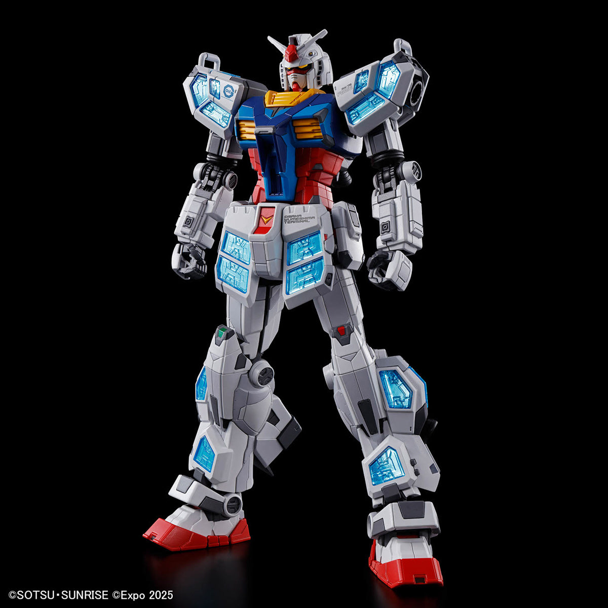 Robot model toy with gray, blue, and red color scheme on a black background