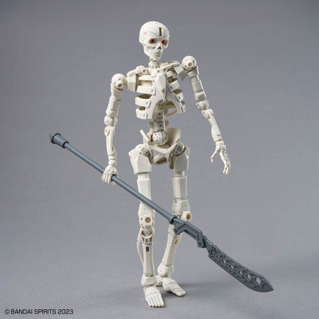 A white articulated skeleton action figure holding a gray scythe, standing on a neutral gray studio background. The copyright text 'BANDAI SPIRITS 2023' is visible in the bottom-left corner.