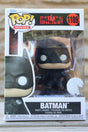 Batman Funko Pop! vinyl figure in packaging on a wooden surface