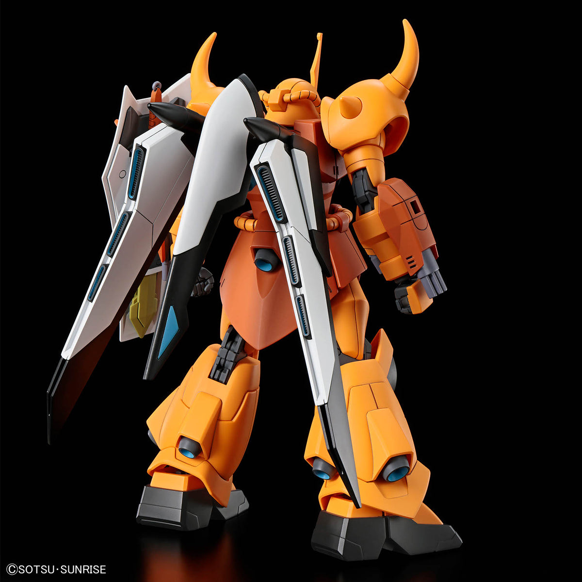 An orange and white mecha robot figure with horned head details, blue eyes, and large angular shields, photographed against a solid black background.