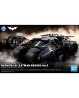 Front packaging artwork for a 1/35 scale model kit of the Batmobile from Batman Begins. The box art features a dramatic black armored vehicle in a smoky battle scene, with the DC logo at top left and the Bandai logo at bottom right.