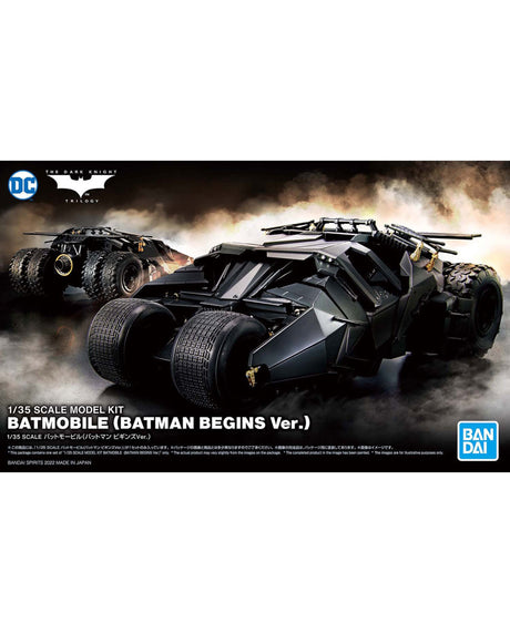 Front packaging artwork for a 1/35 scale model kit of the Batmobile from Batman Begins. The box art features a dramatic black armored vehicle in a smoky battle scene, with the DC logo at top left and the Bandai logo at bottom right.