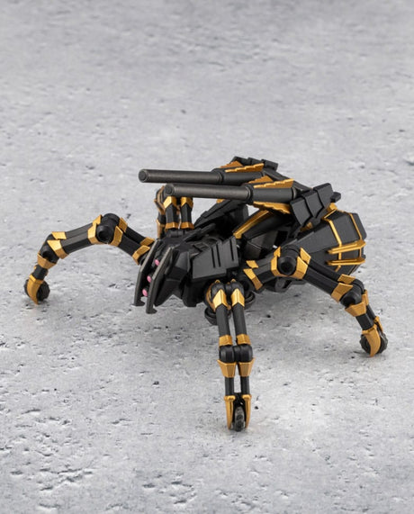 A black and gold robotic spider toy with a mounted gun barrel, posed on a textured gray surface.