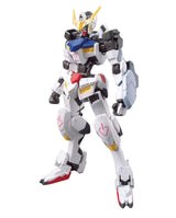 A white Gundam-style mecha action figure with black, blue, yellow, and red details, posed against a plain white background.