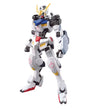 A white Gundam-style mecha action figure with black, blue, yellow, and red details, posed against a plain white background.
