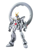 A white and gray mecha robot figure with black detailing, yellow antenna, and a red chest accent, posed in front of a large gray circular ring on a plain white background.