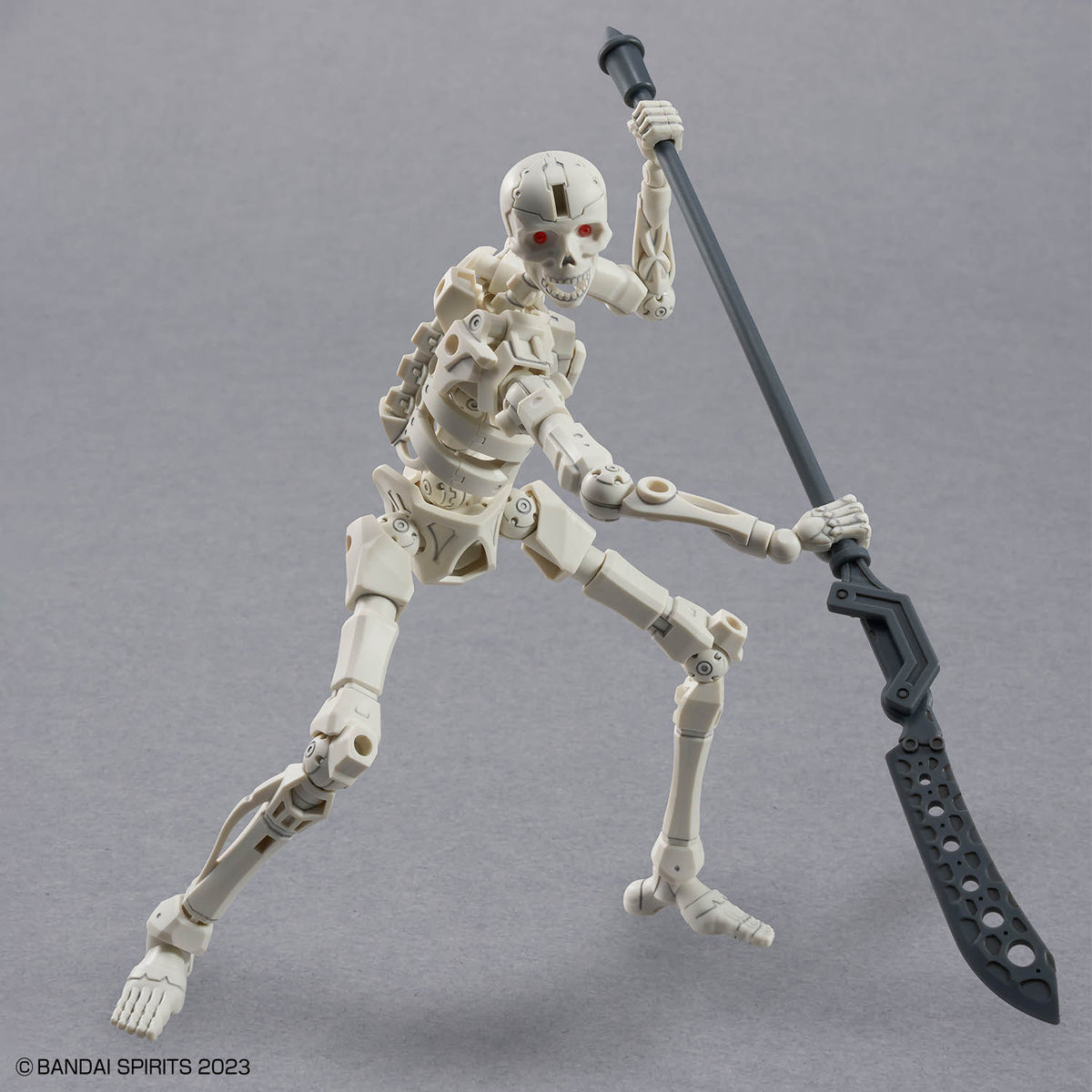 Skeleton figure holding a large sword on a gray background