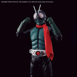 Kamen Rider Shin Kamen Rider action figure posed with arms raised, wearing a dark green and black bodysuit with a bright red cape and silver belt, set against a solid black background.